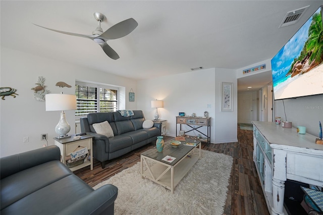 living room featuring ceiling fan and dark hardwood / wood-style flooring