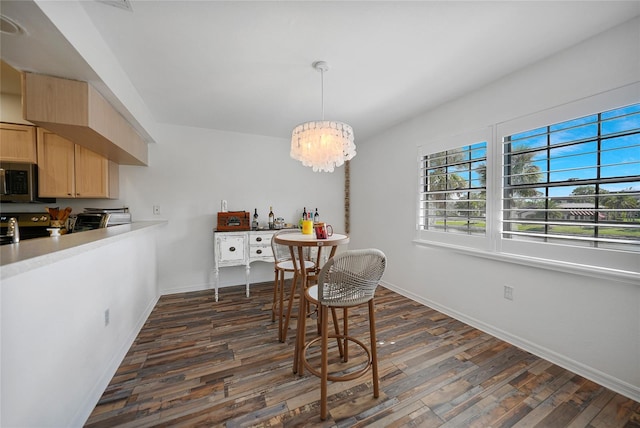 dining area featuring dark hardwood / wood-style floors and a notable chandelier