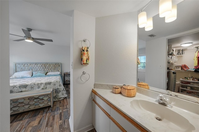 bathroom featuring ceiling fan, wood-type flooring, and vanity