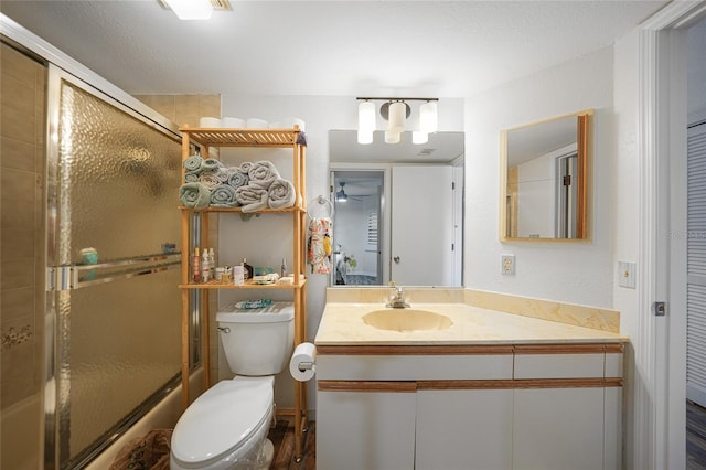 bathroom with vanity, toilet, and a textured ceiling