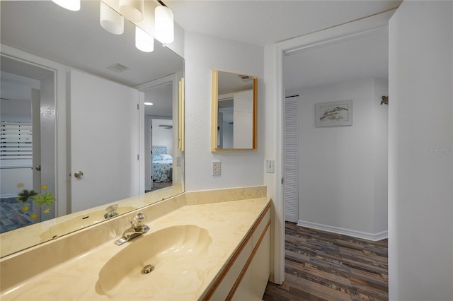 bathroom featuring wood-type flooring and vanity