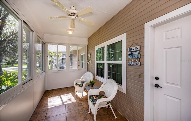 sunroom / solarium featuring ceiling fan