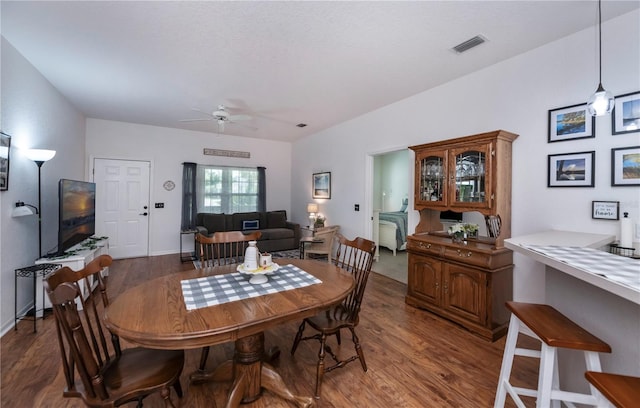 dining area featuring ceiling fan and dark wood-type flooring