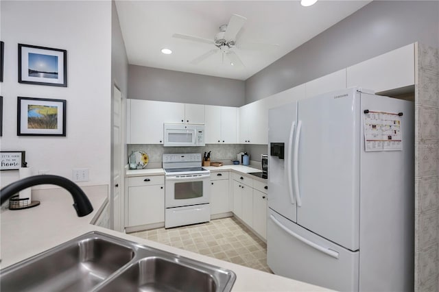 kitchen featuring white cabinetry, sink, white appliances, and backsplash