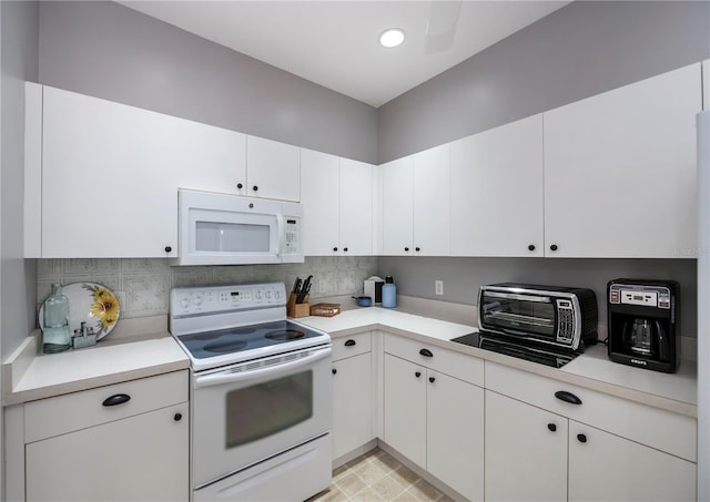 kitchen with white cabinets, white appliances, and tasteful backsplash