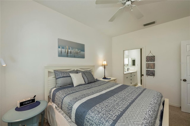 carpeted bedroom with connected bathroom and ceiling fan