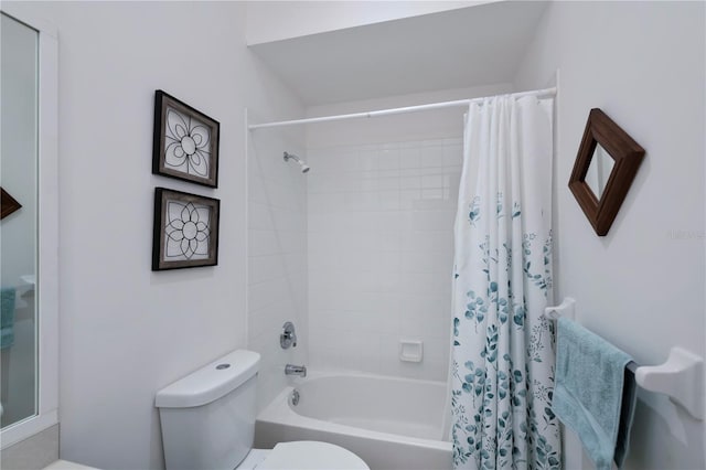 bathroom featuring shower / bath combination with curtain and toilet