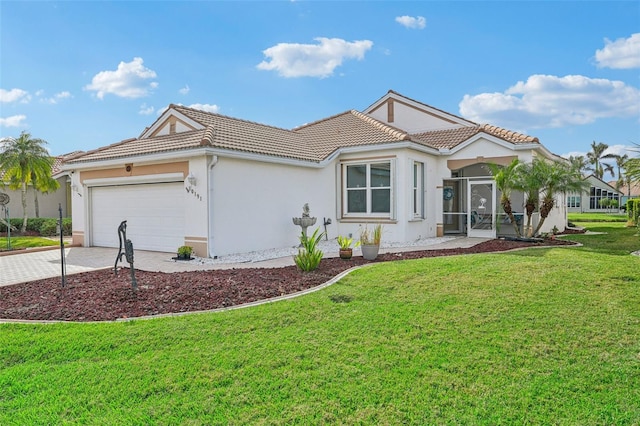 mediterranean / spanish-style house featuring a garage and a front lawn