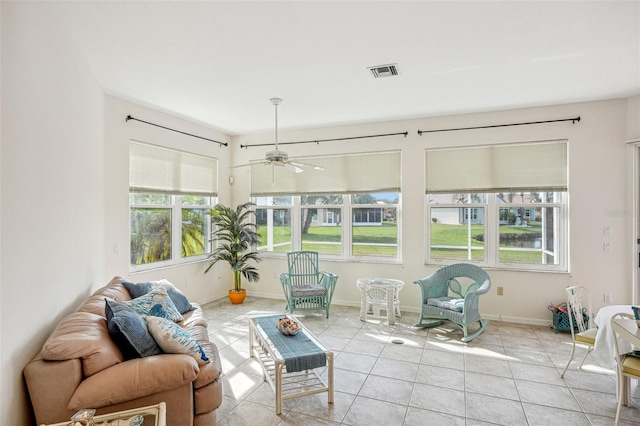 sunroom / solarium featuring ceiling fan