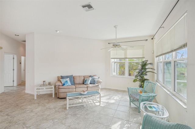 tiled living room featuring ceiling fan