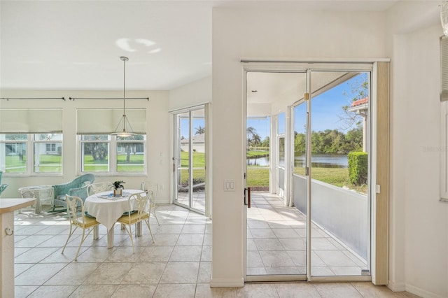 interior space featuring a water view and light tile patterned flooring