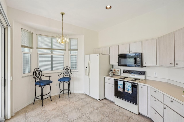 kitchen featuring an inviting chandelier, vaulted ceiling, decorative light fixtures, white appliances, and light tile patterned floors