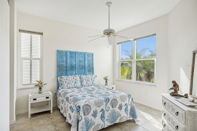 tiled bedroom featuring ceiling fan