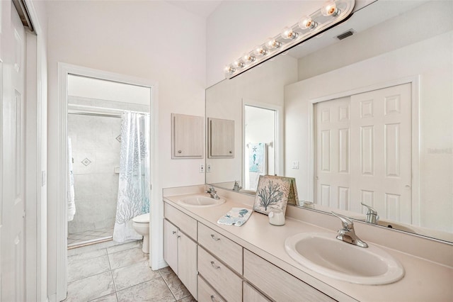 bathroom featuring tile patterned floors, vanity, a shower with shower curtain, and toilet