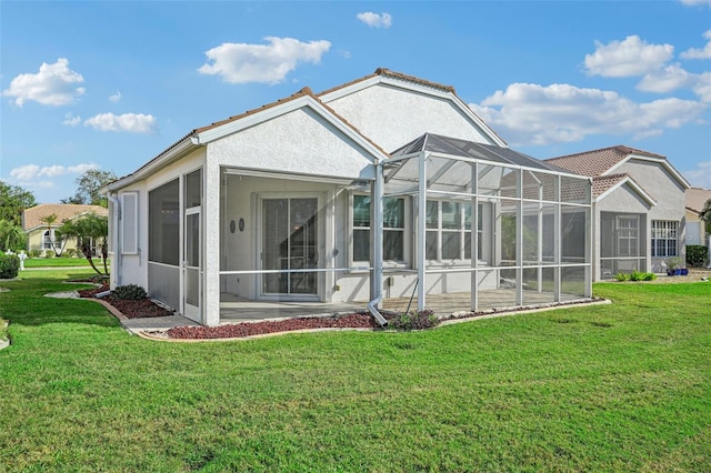 back of house featuring a yard and a lanai