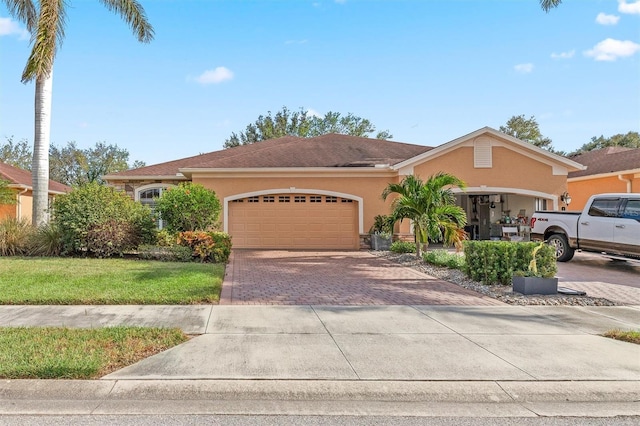 4410 Turnberry Cir, North Port, FL 34288 - view of front of property featuring decorative driveway, stucco siding, an attached garage, and a front lawn