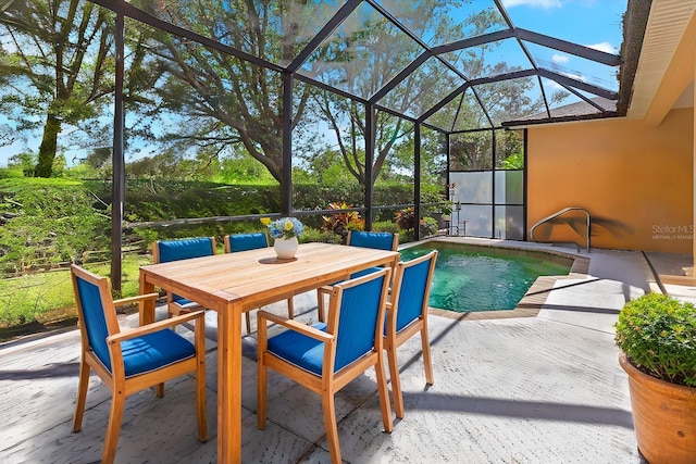 view of swimming pool featuring a lanai, outdoor dining space, and a patio area