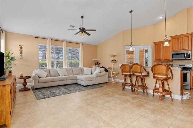 4410 Turnberry Cir, North Port, FL 34288 - living area featuring ceiling fan, lofted ceiling, light tile patterned floors, and baseboards