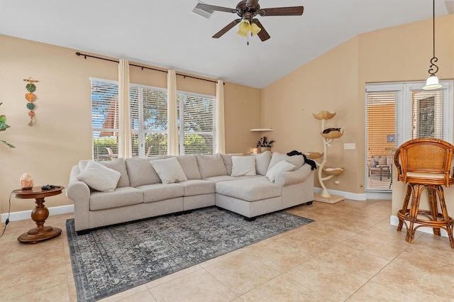 living room featuring ceiling fan, light tile patterned floors, and vaulted ceiling