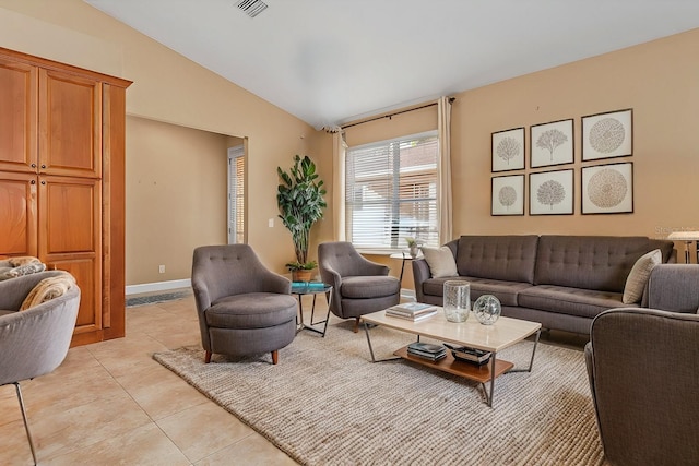 living room with light tile patterned floors and vaulted ceiling