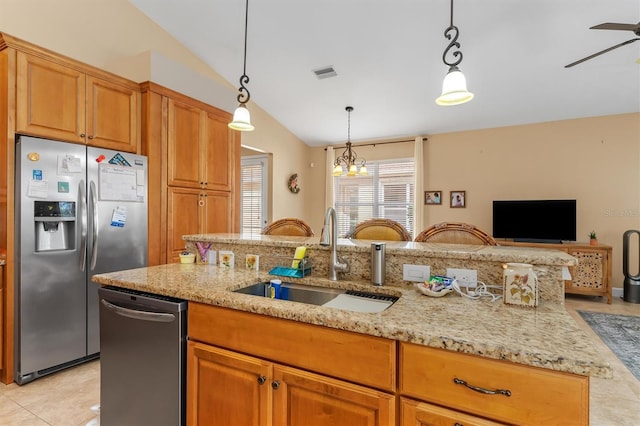 kitchen featuring stainless steel appliances, sink, pendant lighting, light tile patterned floors, and lofted ceiling