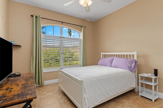 tiled bedroom featuring ceiling fan