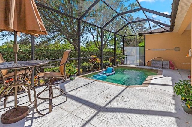 view of pool featuring a patio and glass enclosure