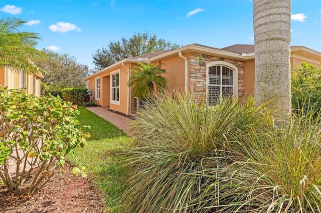 4410 Turnberry Cir, North Port, FL 34288 - view of property exterior featuring stucco siding and stone siding
