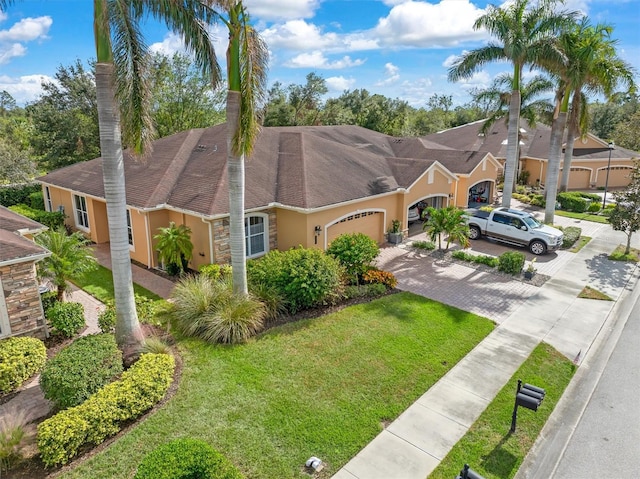 view of front of property featuring a garage and a front lawn