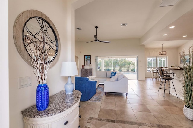 living room featuring ceiling fan and light tile patterned flooring