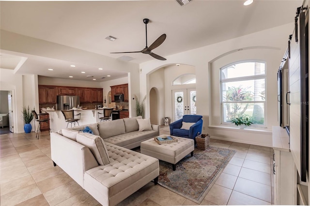 living room with ceiling fan, french doors, and light tile patterned floors