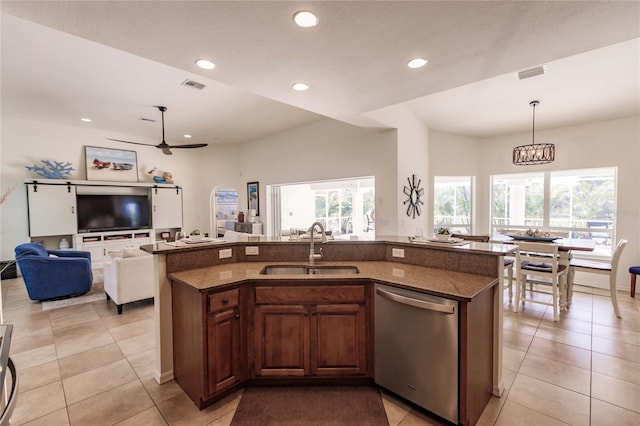 kitchen featuring stainless steel dishwasher, plenty of natural light, sink, and a kitchen island with sink