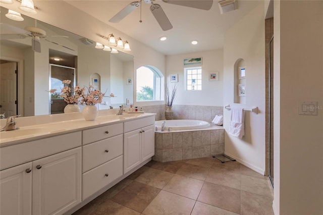 bathroom with plus walk in shower, tile patterned flooring, vanity, and ceiling fan