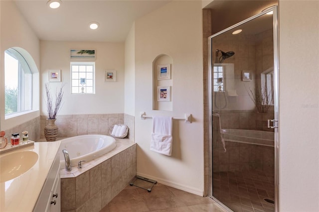 bathroom with tile patterned floors, plus walk in shower, and vanity