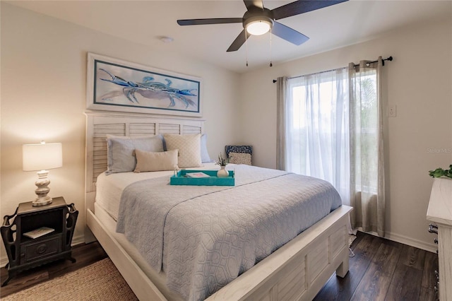 bedroom with dark hardwood / wood-style floors and ceiling fan