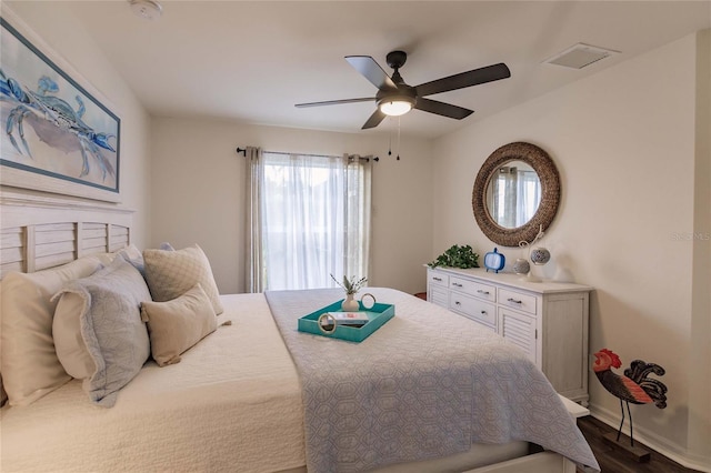 bedroom with dark hardwood / wood-style floors and ceiling fan