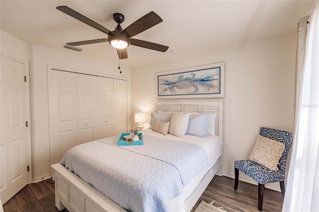 bedroom with a closet, ceiling fan, and dark wood-type flooring