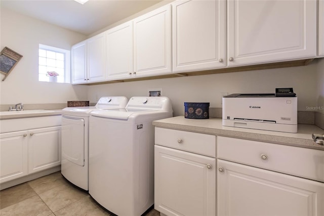 laundry room with washer and clothes dryer, sink, light tile patterned floors, and cabinets