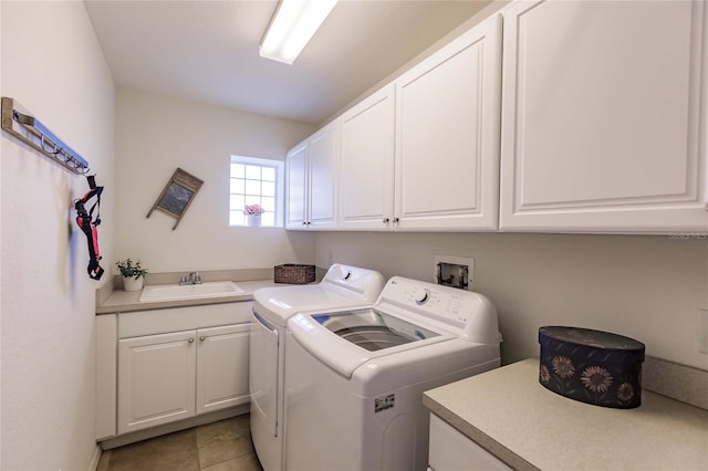 clothes washing area with separate washer and dryer, sink, light tile patterned floors, and cabinets