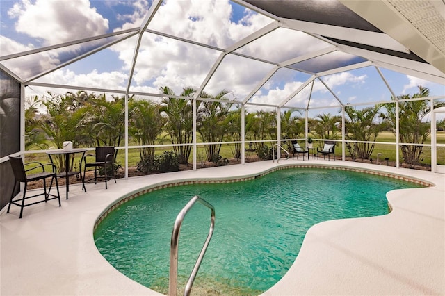 view of swimming pool featuring a patio and a lanai