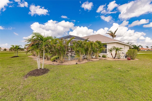 exterior space with a lawn and a lanai