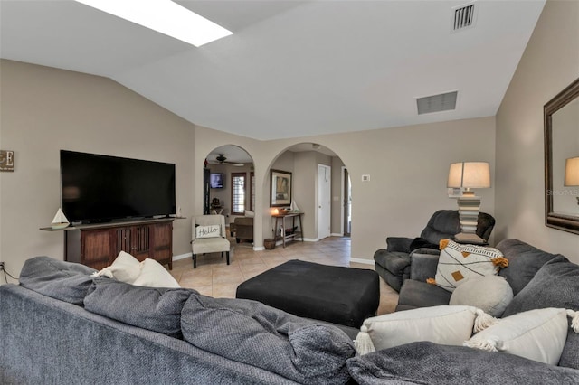 living room featuring vaulted ceiling, ceiling fan, and light tile patterned flooring