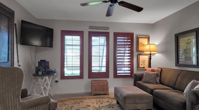 interior space featuring wood-type flooring and ceiling fan