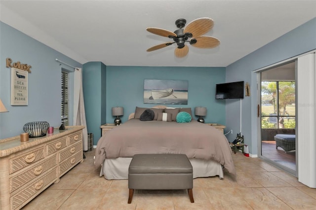 bedroom with access to exterior, light tile patterned floors, and ceiling fan