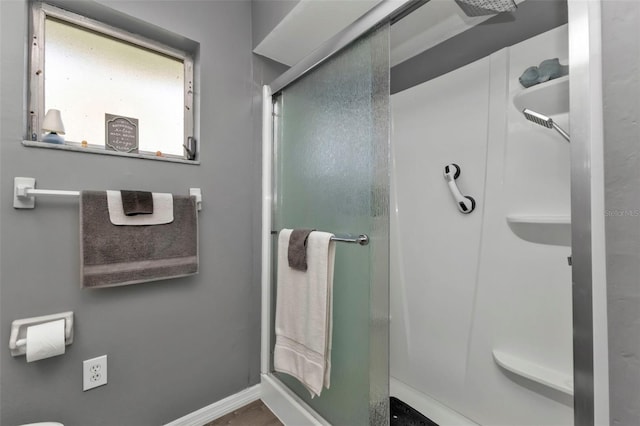 bathroom featuring a shower with door