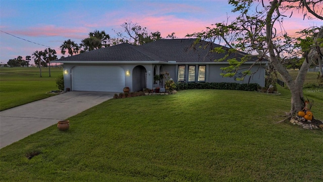 single story home with a lawn and a garage