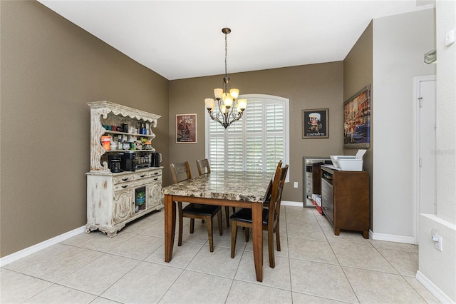 tiled dining area featuring a chandelier