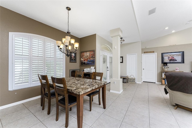 dining area featuring light tile patterned floors, an inviting chandelier, and lofted ceiling