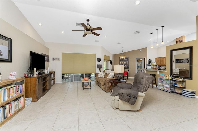 living room with ceiling fan, light tile patterned floors, and vaulted ceiling