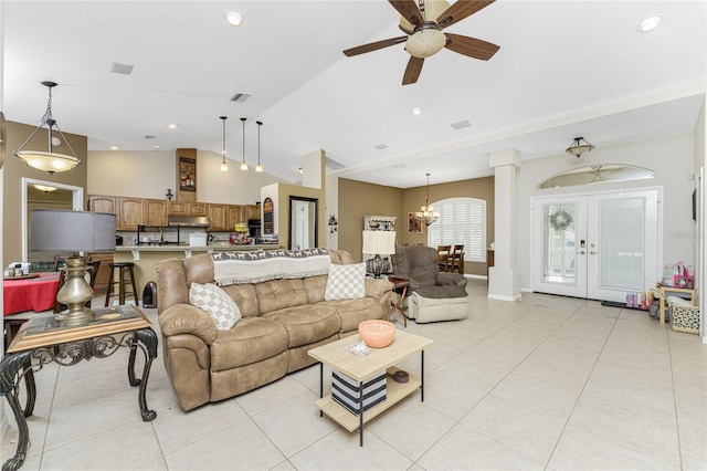 living room featuring ceiling fan with notable chandelier, french doors, light tile patterned flooring, and lofted ceiling